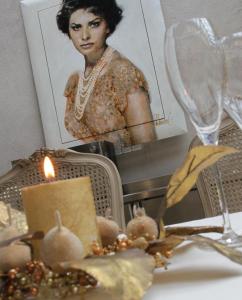 a woman sitting at a table in front of a candle at Boutique Hotel Casa Granados in Tossa de Mar