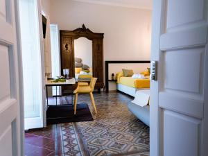 a bedroom with a bed and a desk with a chair at Dimora Cavour in Amantea