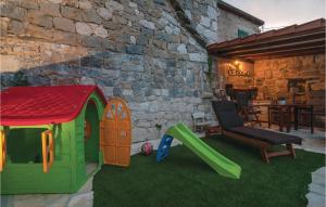 a play set with a slide and a chair at Nice Home In Srinjine With Wifi in Srinjine