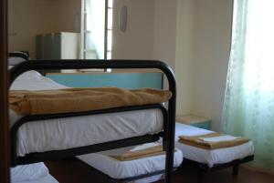 Postel nebo postele na pokoji v ubytování Il Chiostro Hostel and Hotel