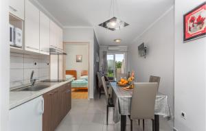 a kitchen and dining room with a table and chairs at Beautiful Apartment In Pinezici With Wifi in Pinezici