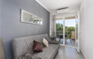a living room with a couch and a balcony at Beautiful Apartment In Pinezici in Pinezici