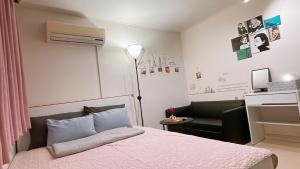 a bedroom with a bed and a chair and a desk at Ellen House in Seoul