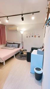 a living room with a bed and a table at Ellen House in Seoul