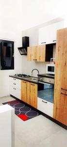 a kitchen with white cabinets and a stove top oven at ANDIRIVIENI☆LECCE ☆CASA VACANZE LECCE in Lecce