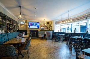 a restaurant with tables and chairs and a bar at Fox Inn in Guisborough