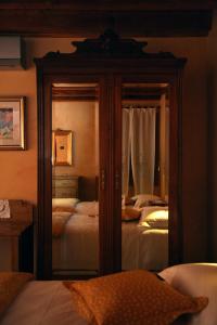 a bedroom with two beds and a mirror at La Quiete Bed & Breakfast in Brendola