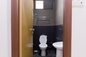 a bathroom with a toilet and a sink at Villa Sri Mayang in Kuala Terengganu