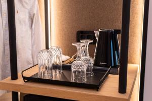 a tray with glasses and a pitcher on a table at Chora Suites, Premium Key Collection in Skiathos Town