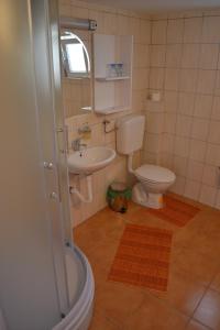 a bathroom with a toilet and a sink at Guesthouse Kruna Višegrad in Višegrad