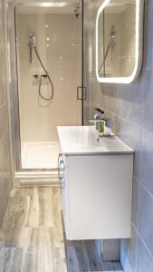 a bathroom with a white sink and a shower at Luxury Apartment In The Heart of Leicester With Parking in Leicester