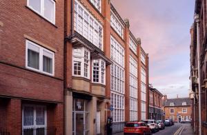 a row of brick buildings on a city street at Luxury Apartment In The Heart of Leicester With Parking in Leicester