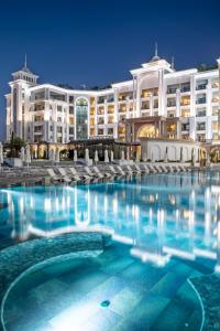 a swimming pool in front of a large building at Merit Royal Diamond Hotel & SPA in Kyrenia