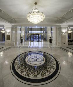 a large lobby with a clock on the floor at Merit Royal Diamond Hotel & SPA in Kyrenia