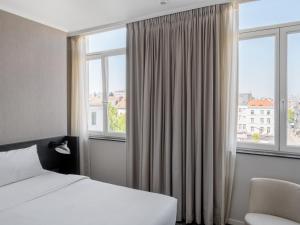 a hotel room with a bed and a window at numa l Lief in Brussels