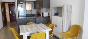 a kitchen with a table and chairs and a refrigerator at Ca Vicent in Calpe