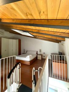a bedroom with a bed and a wooden ceiling at Easy Milano - Rooms and Apartments Navigli in Milan +165 photos