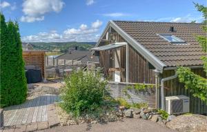 a house with a patio and a deck at Beautiful Home In Henn With Kitchen in Henån