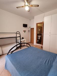 a bedroom with a bed and a ceiling fan at Hotel Riz in Finale Ligure