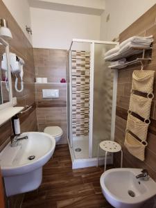 a bathroom with a sink and a shower at Hotel Riz in Finale Ligure