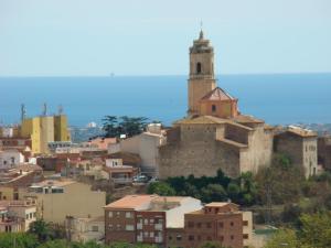 a view of a city with a church on a hill at Can Clapa in Les Borges del Camp