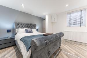 a bedroom with a large bed and a large window at Tanna Estates - George Street House in Leamington Spa