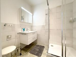 a bathroom with a shower and a sink and a toilet at Pärchentraum im Zentrum von Graz in Graz