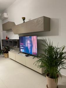 a living room with a flat screen tv on a counter at Green Coast 136 in Dhërmi