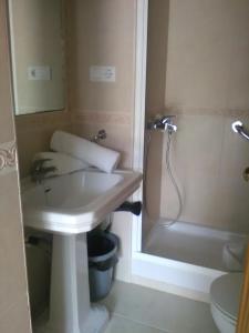 a bathroom with a sink and a shower and a toilet at El Jardin BeNerja in Nerja