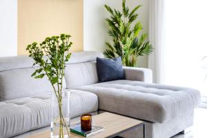 a living room with a couch and a coffee table at Unlock Metropolis Business Bay in Dubai