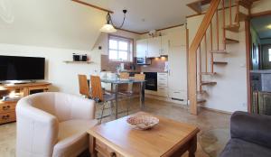 uma sala de estar com um sofá, uma mesa e uma cozinha em Haus Norway Trondheim em Wittenbeck