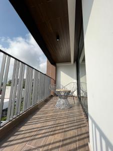瓦哈卡德華雷斯的住宿－Zen Suites by Regente，大楼内的阳台配有两把椅子和一张桌子