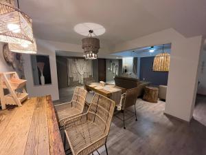 a living room with a table and chairs and a dining room at Zen Suites by Regente in Oaxaca City