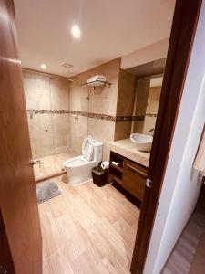 a bathroom with a toilet and a sink at Zen Suites by Regente in Oaxaca City +140 photos