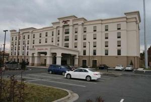 a white car parked in front of a building at Hampton Inn Hickory in Hickory