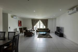 a living room with a couch and a table and chairs at Accra Fine Suites - Henrietta's Residences in Accra +37 photos
