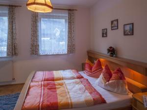 1 dormitorio con 1 cama grande con almohadas rojas en Haus Schönegger, en Dorfgastein