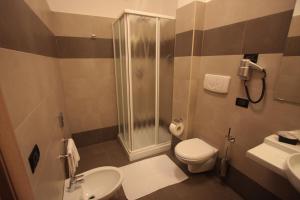 a bathroom with a shower and a toilet and a sink at Life Sport Hotel in Mentana