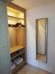 a walk in closet with a mirror and towels at Ferienwohnung Anneliese Eckhart in Anger