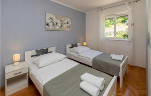 Postel nebo postele na pokoji v ubytování Holiday Home Rabac 13