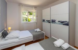 Postel nebo postele na pokoji v ubytování Holiday Home Rabac 13