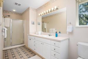 a white bathroom with a sink and a shower at Artisan in Cloverdale +38 photos