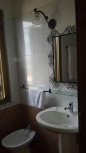 a bathroom with a sink and a mirror at Bed and Breakfast Coral Blue in Briatico