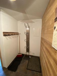 a room with a wood paneled wall and a shelf at Chalet Tschengla in Bürserberg