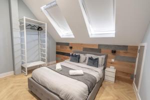 a bedroom with a large bed and skylights at Corporate Suite in Hookwood
