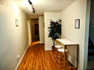 a hallway with a table and stools and a plant at Room in Guest room - Cozy Bedroom close to downtown in Baltimore