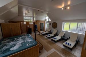 a large room with a jacuzzi tub in a room at Croydon Hall in Minehead