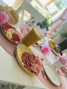 a table with plates of food on top at Gold Horse Vendégház in Szilvásvárad