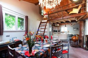 a dining room with a table and a loft bed at L'Audace in Mâcot La Plagne