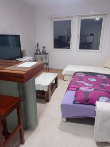 a bedroom with a bed and a desk and a computer at Apartments Ćemo in Sarajevo
